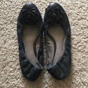 Black leather flats with floral detail
